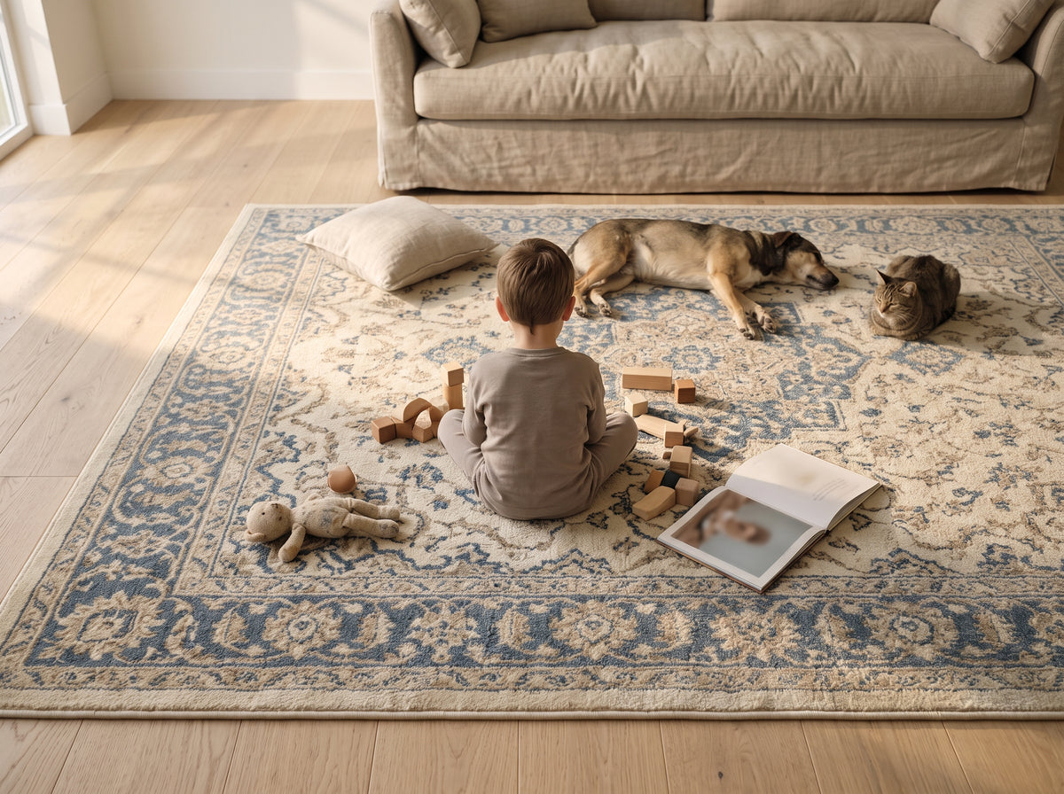 The rug at the foot of a bed with a cat asleep on it.