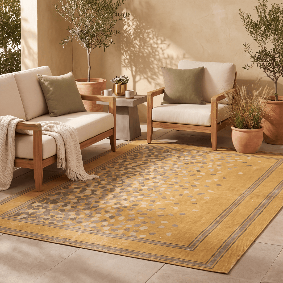 The rug laid flat on a patio beside outdoor seating.