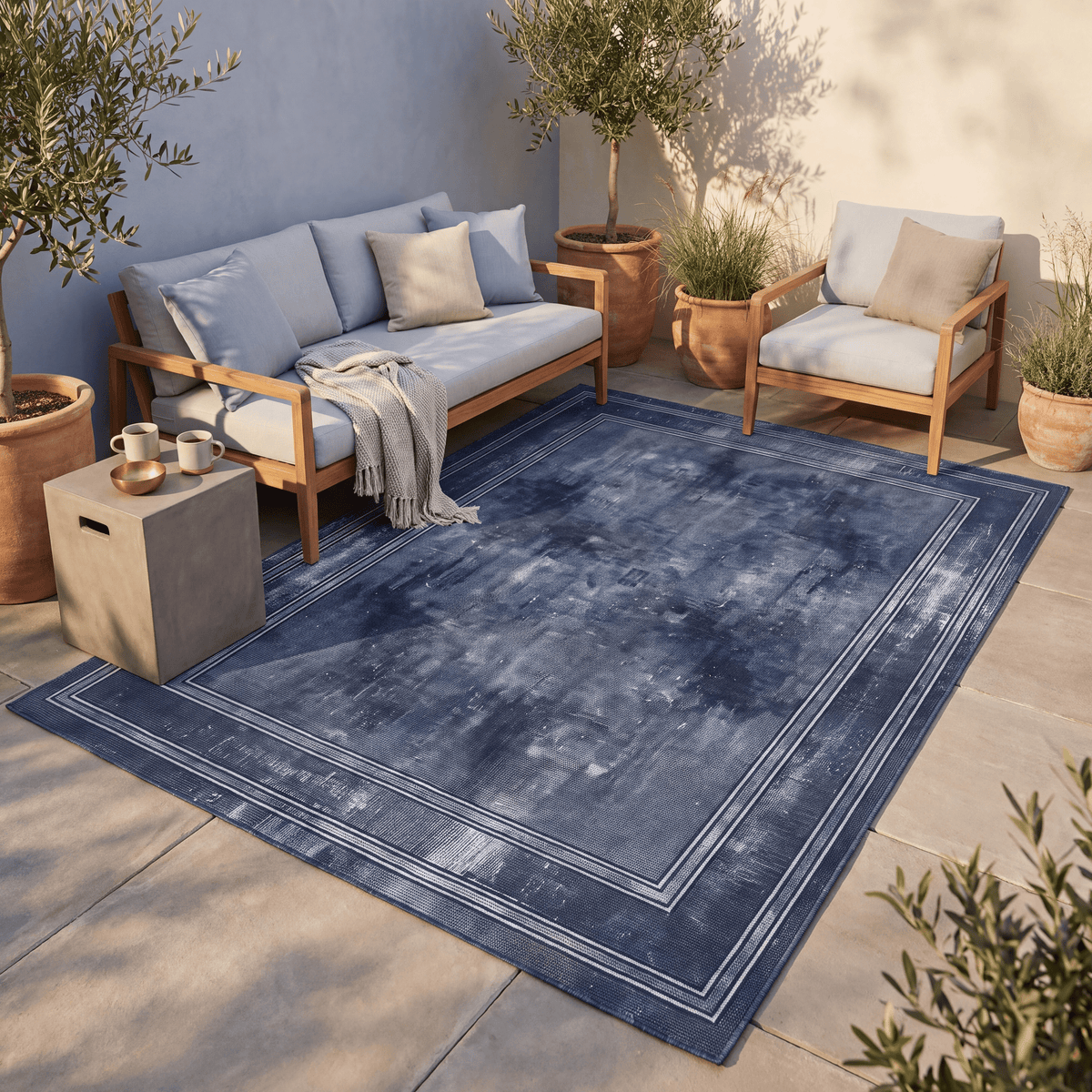 The rug laid flat on a patio beside outdoor seating.