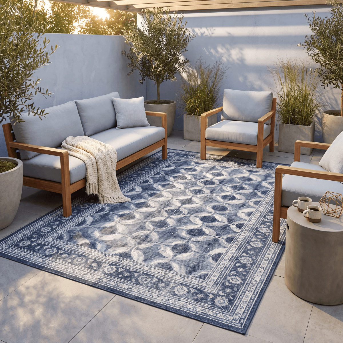 The rug laid flat on a patio beside outdoor seating.