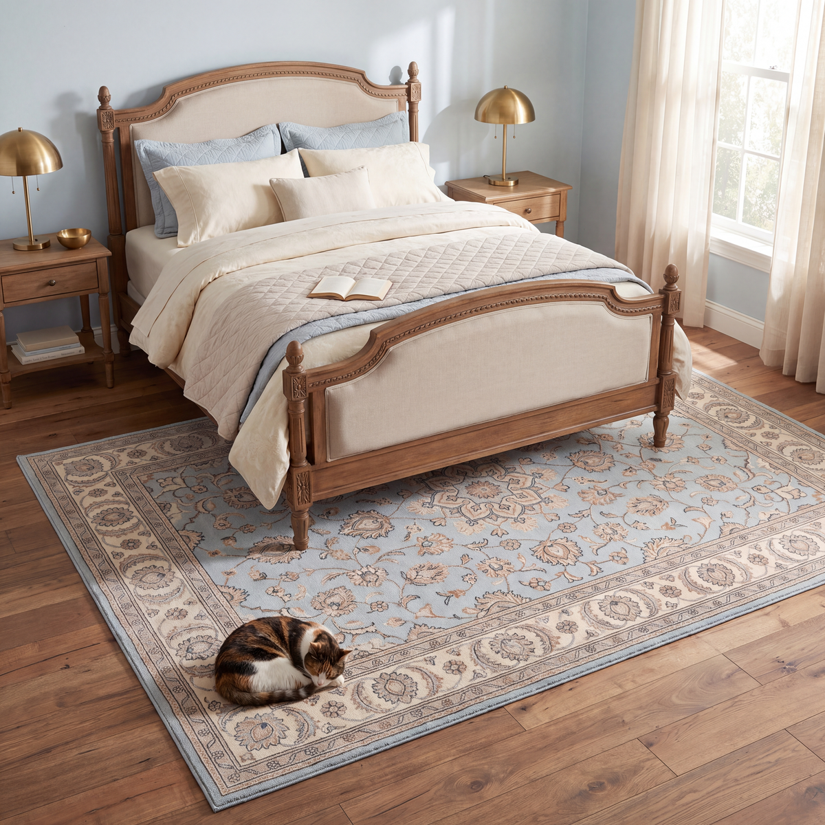 The rug at the foot of a bed with a cat asleep on it.