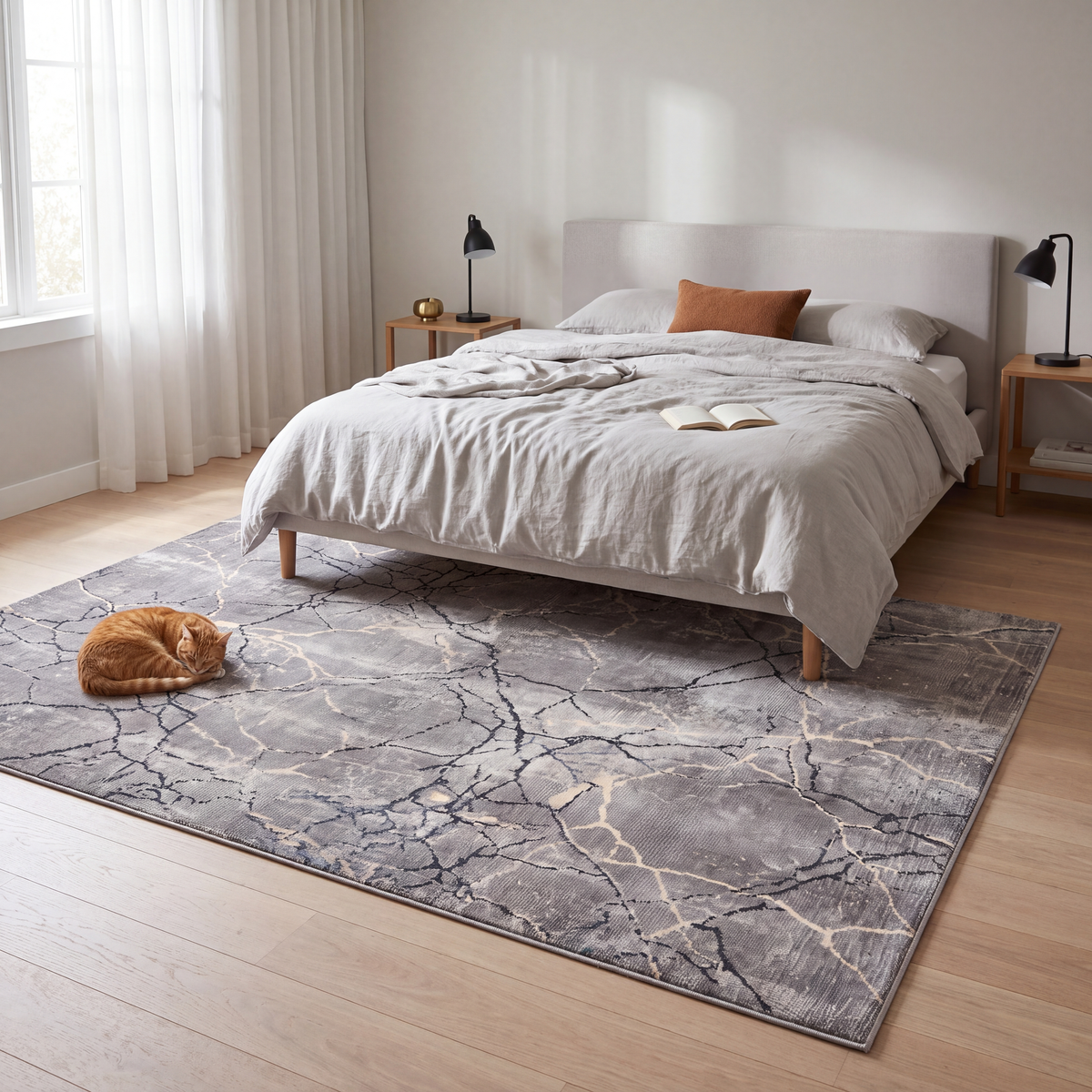 The rug at the foot of a bed with a cat asleep on it.