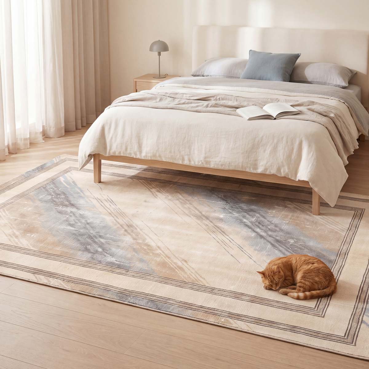 The rug at the foot of a bed with a cat asleep on it.