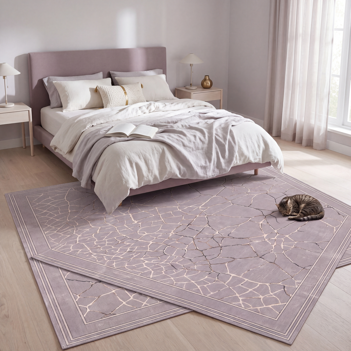 The rug at the foot of a bed with a cat asleep on it.