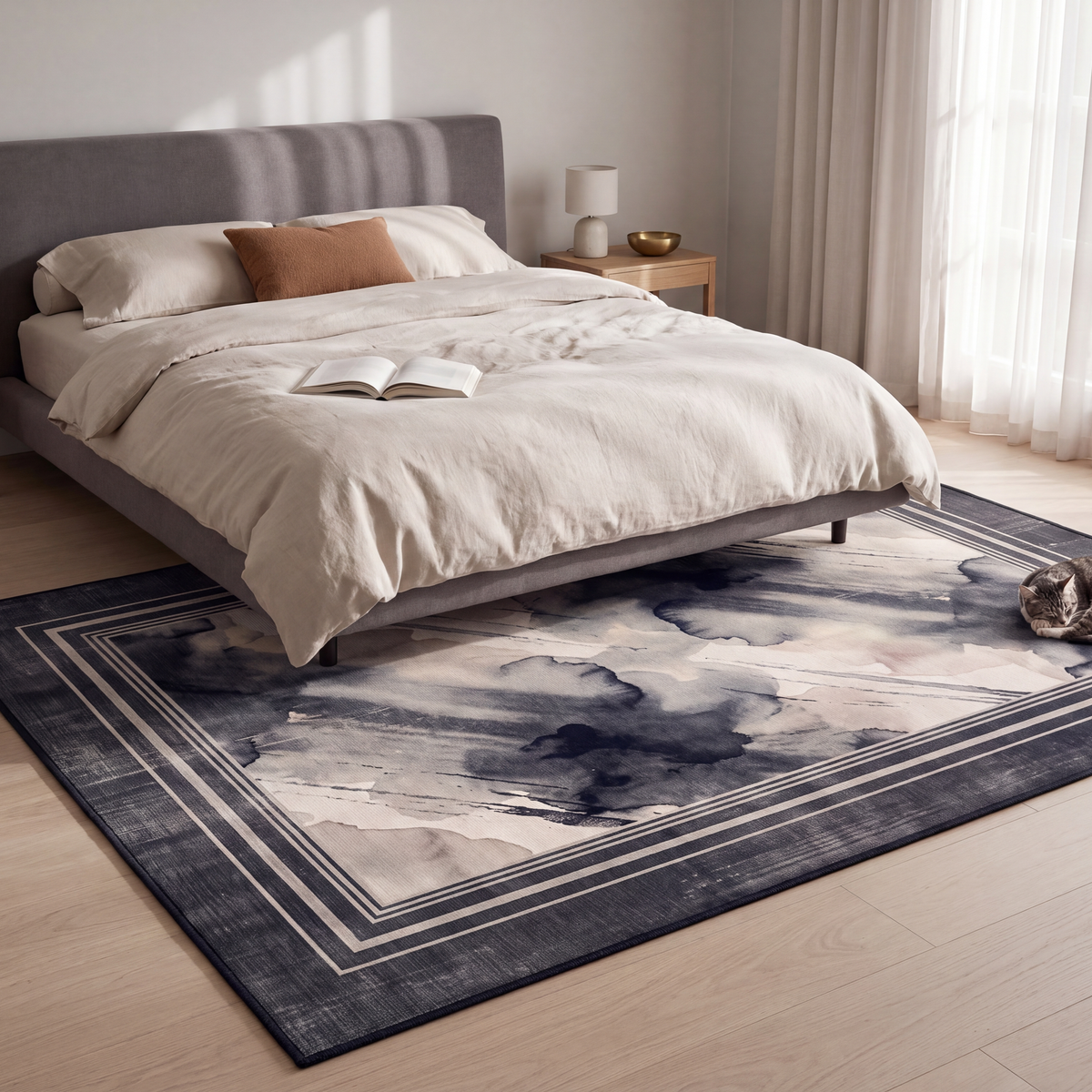 The rug at the foot of a bed with a cat asleep on it.