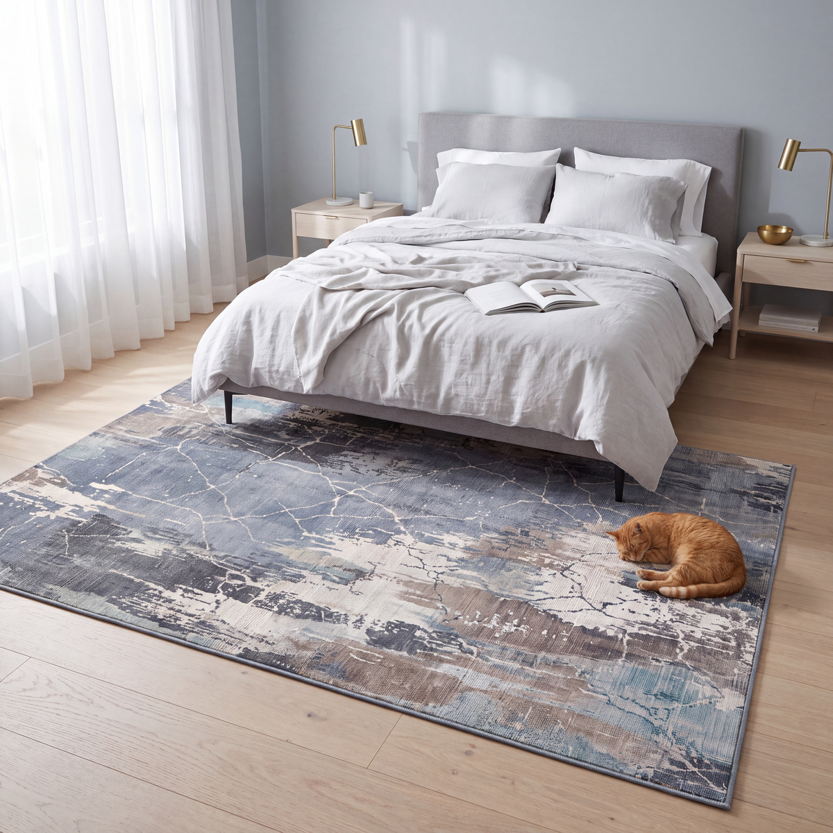 The rug at the foot of a bed with a cat asleep on it.