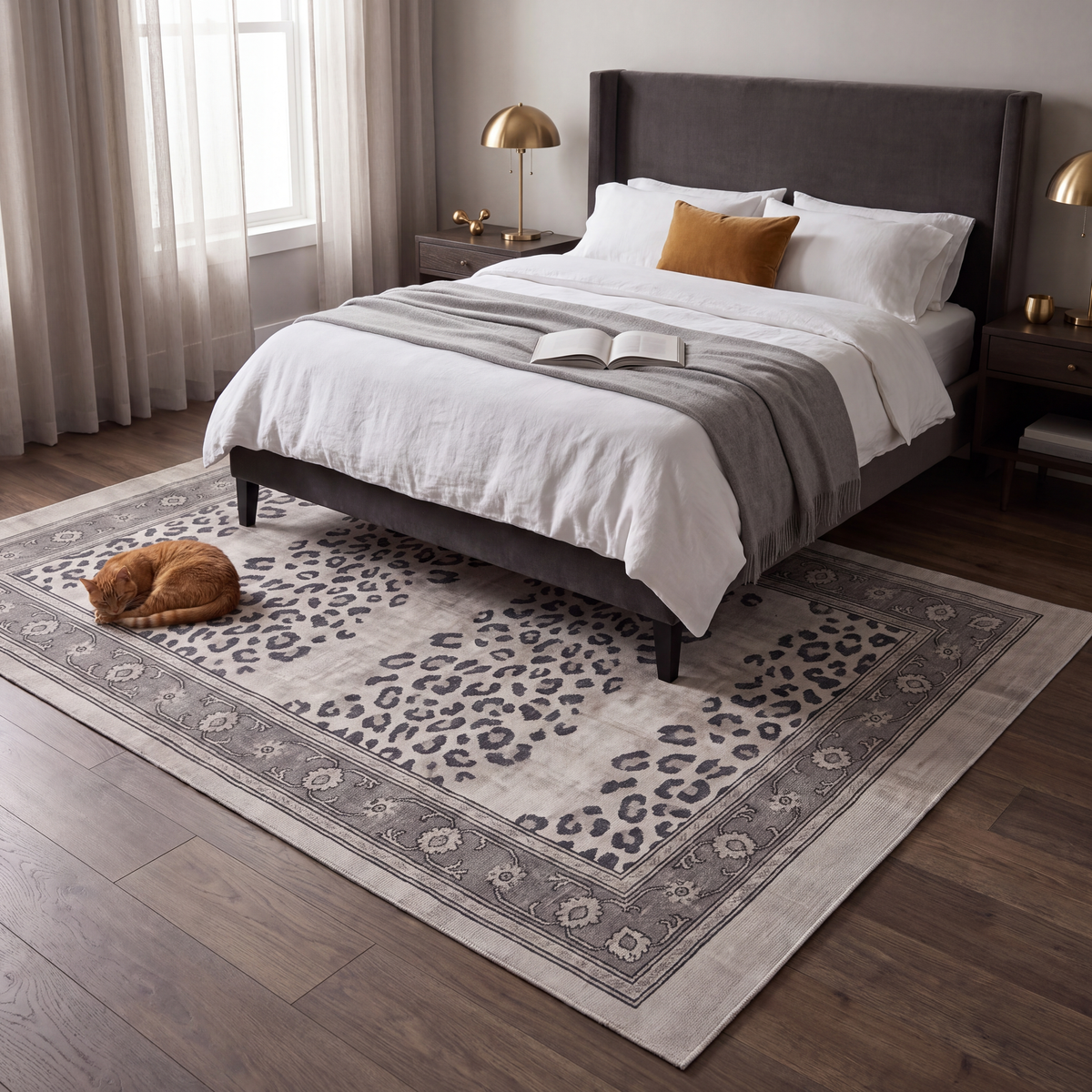 The rug at the foot of a bed with a cat asleep on it.