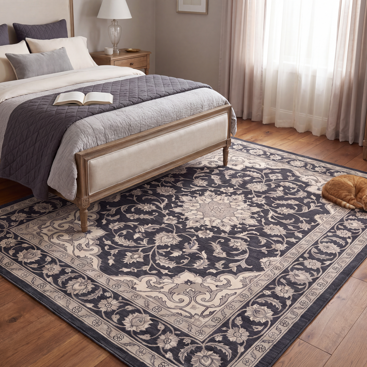 The rug at the foot of a bed with a cat asleep on it.