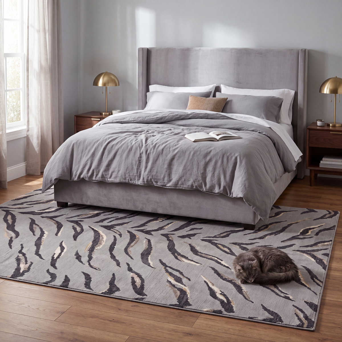The rug at the foot of a bed with a cat asleep on it.