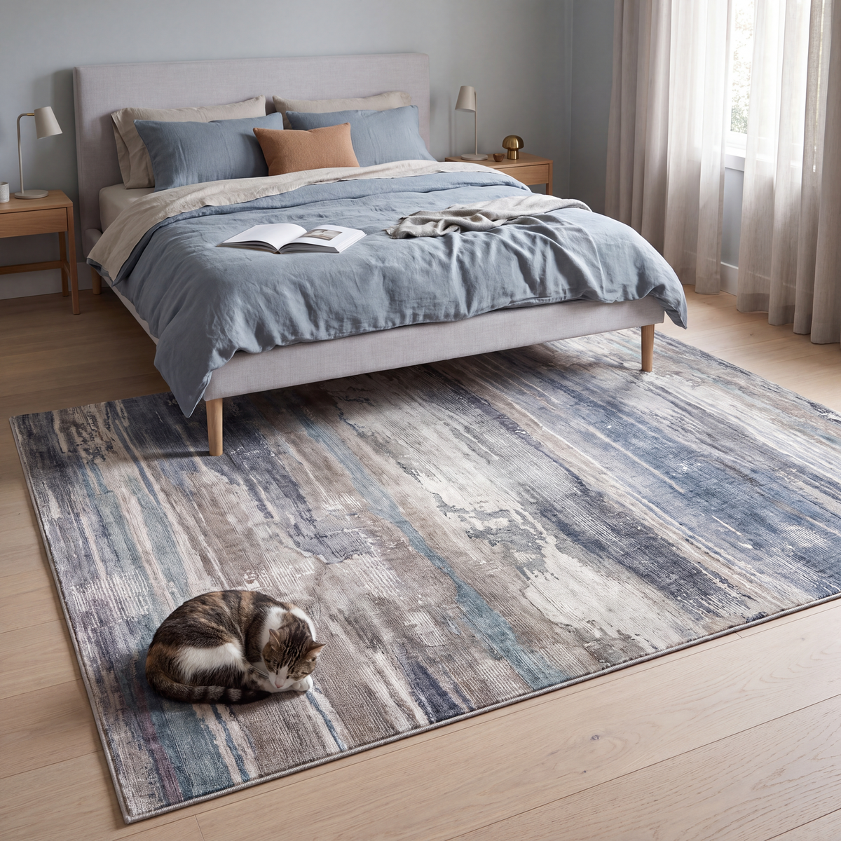 The rug at the foot of a bed with a cat asleep on it.