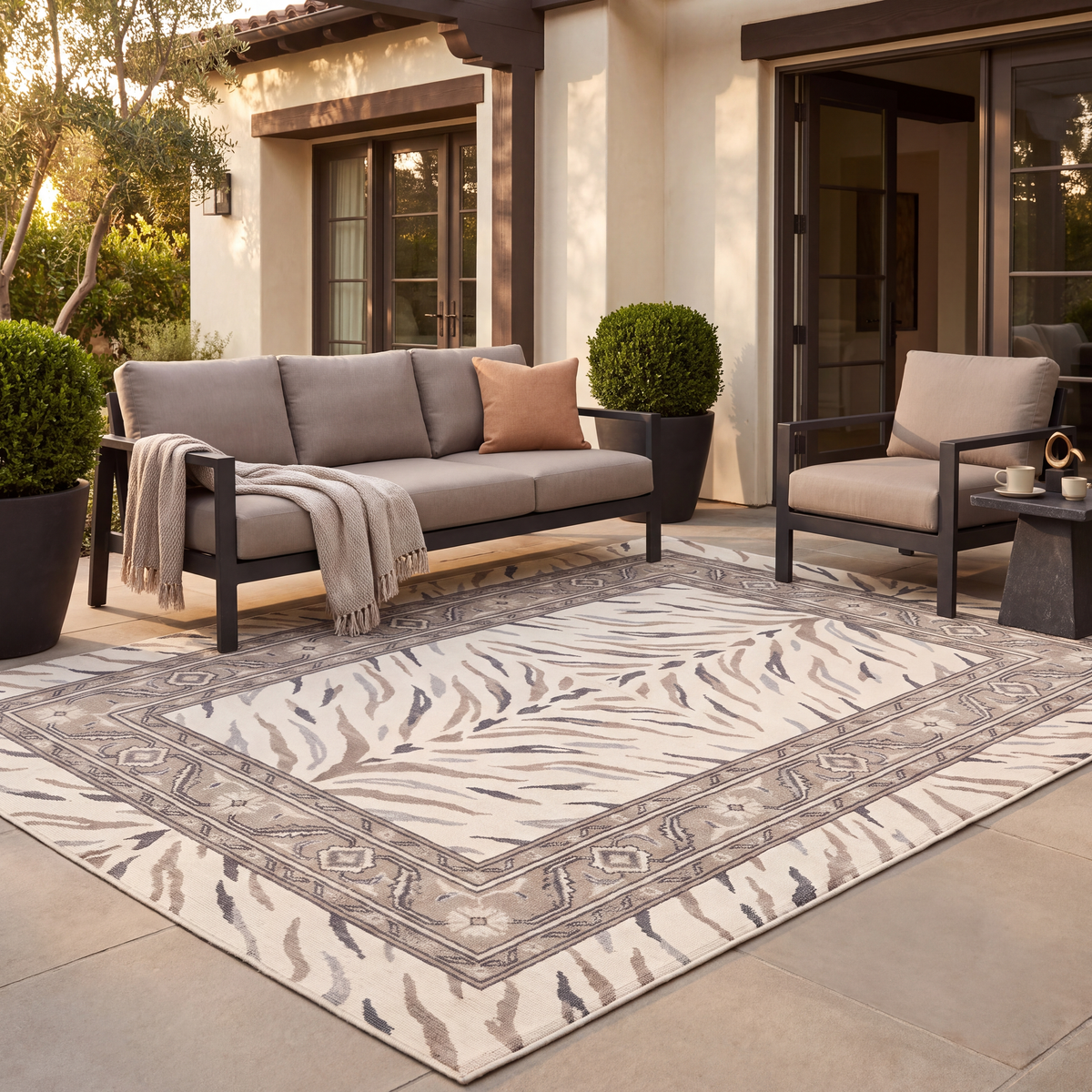 The rug laid flat on a patio beside outdoor seating.