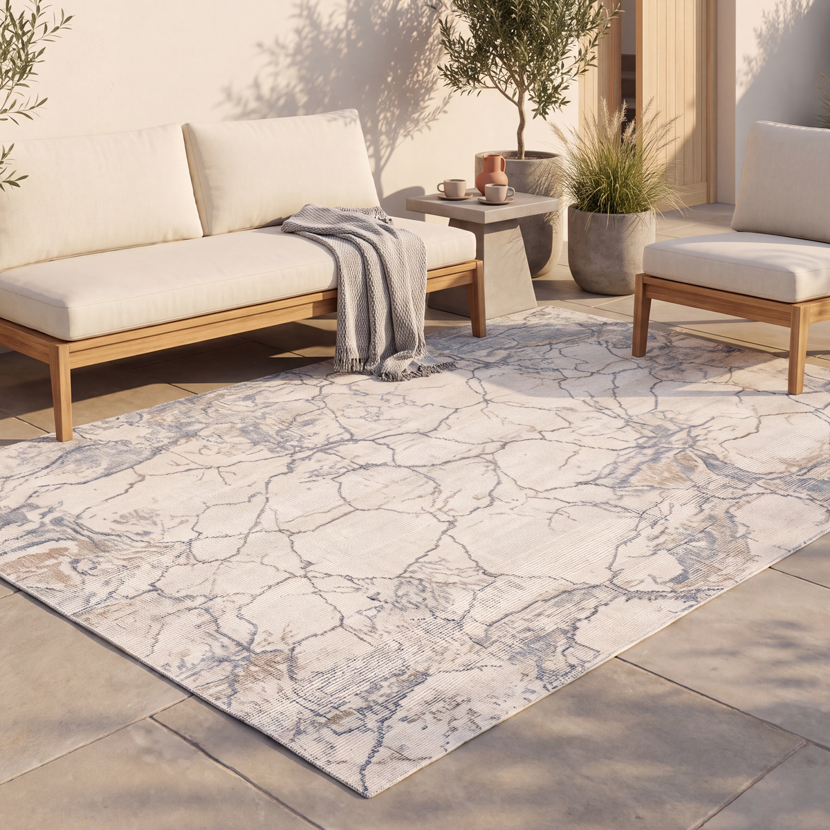 The rug laid flat on a patio beside outdoor seating.