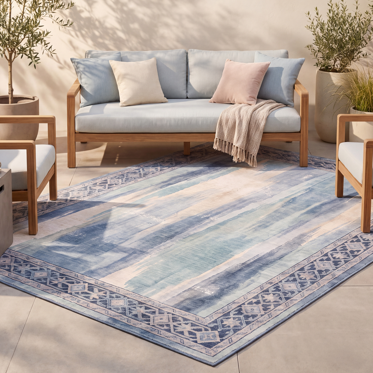 The rug laid flat on a patio beside outdoor seating.