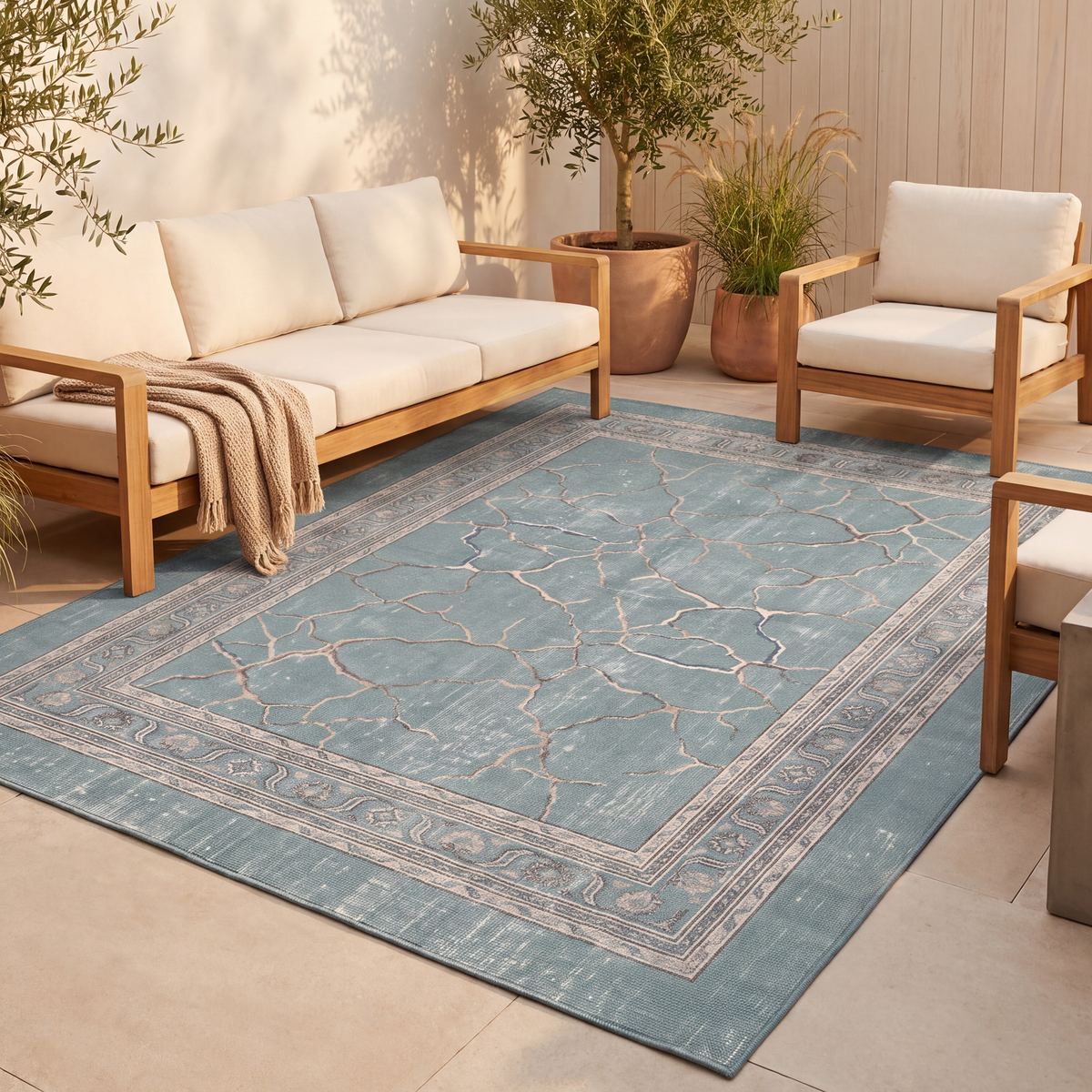 The rug laid flat on a patio beside outdoor seating.