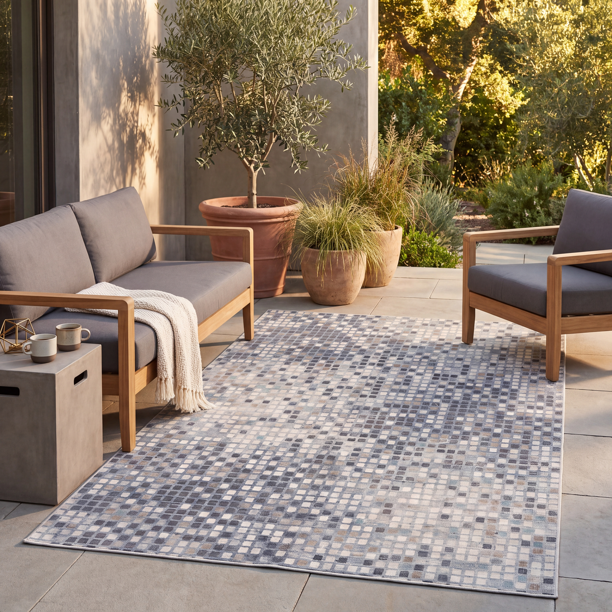 The rug laid flat on a patio beside outdoor seating.