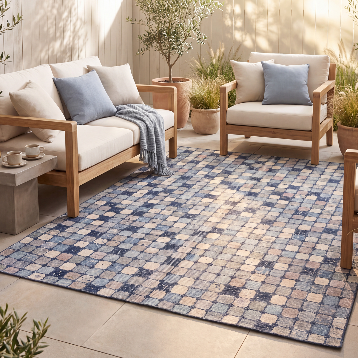 The rug laid flat on a patio beside outdoor seating.