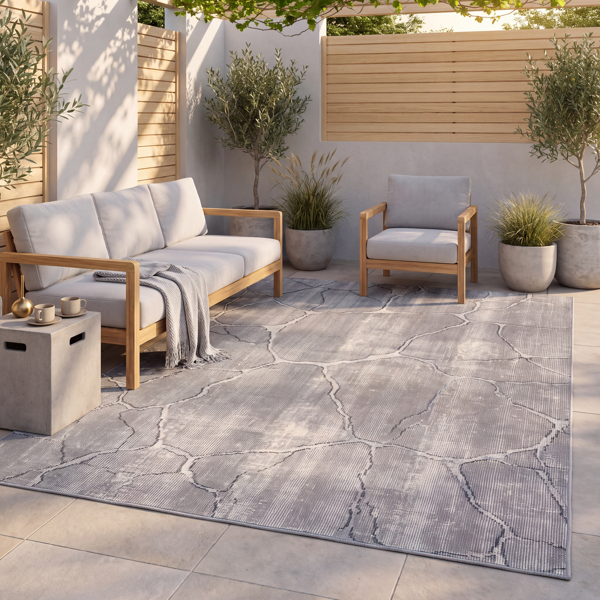 The rug laid flat on a patio beside outdoor seating.
