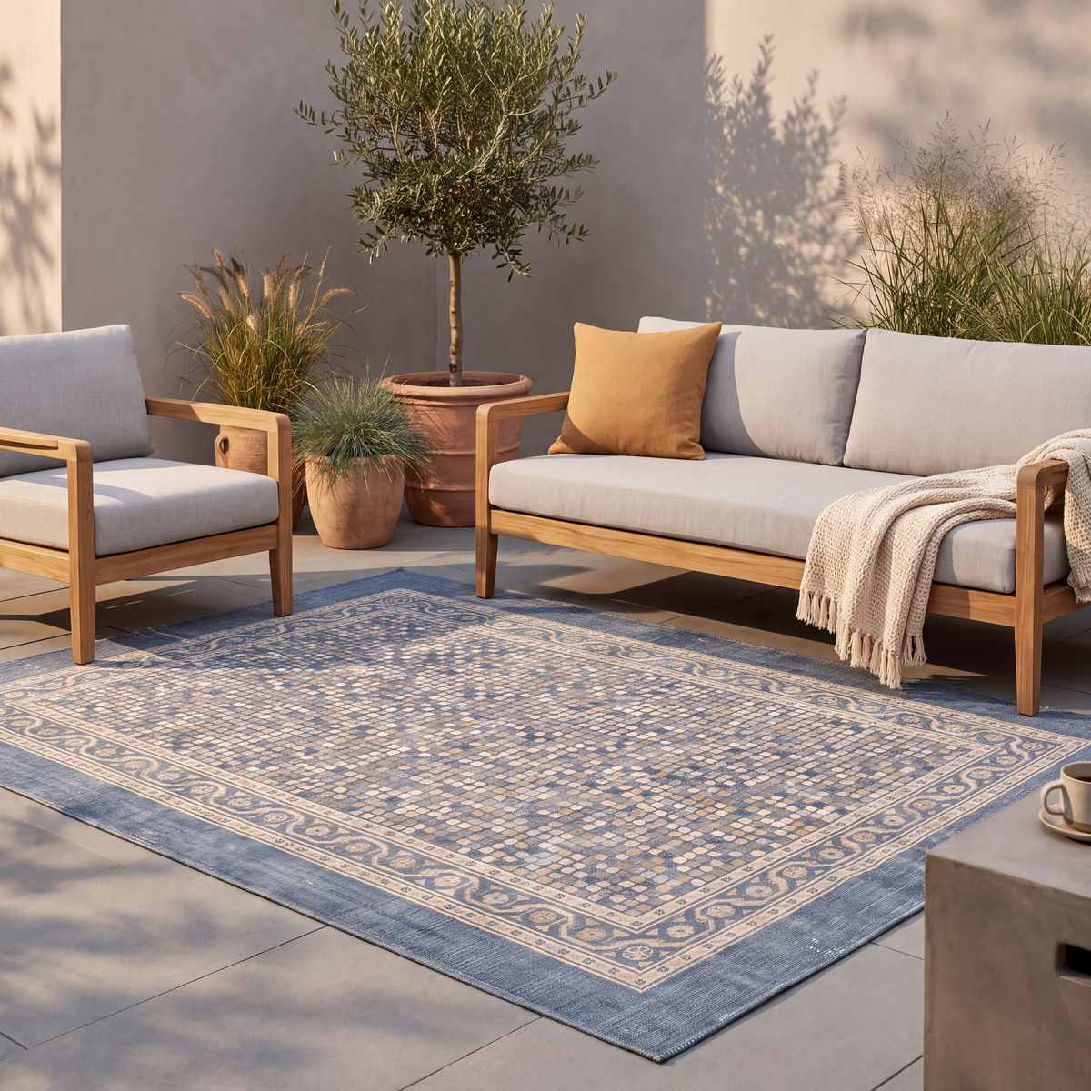 The rug laid flat on a patio beside outdoor seating.