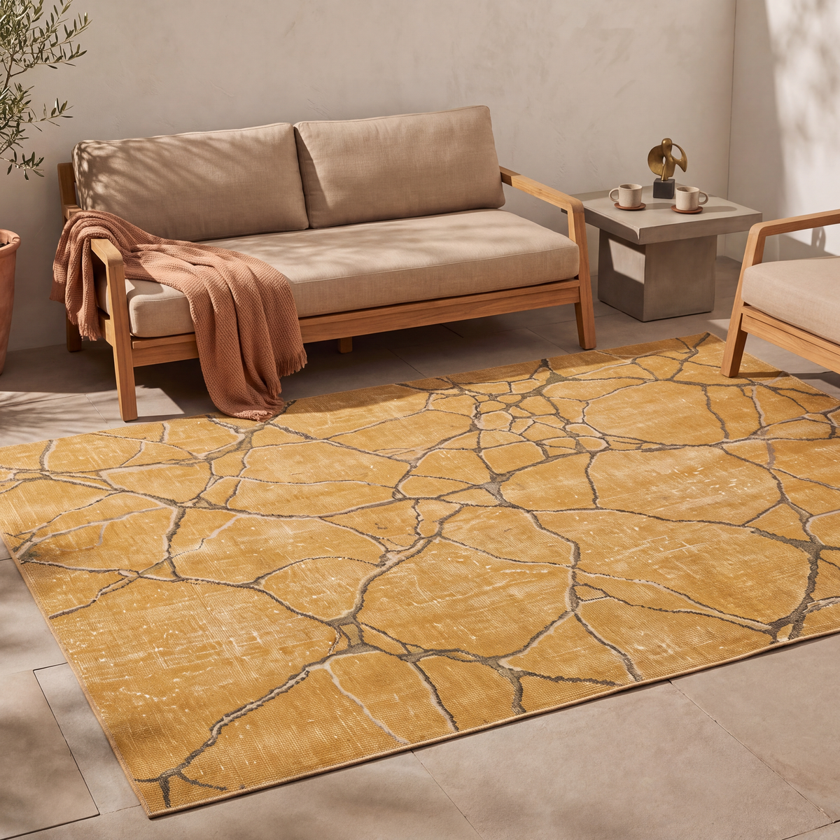 The rug laid flat on a patio beside outdoor seating.