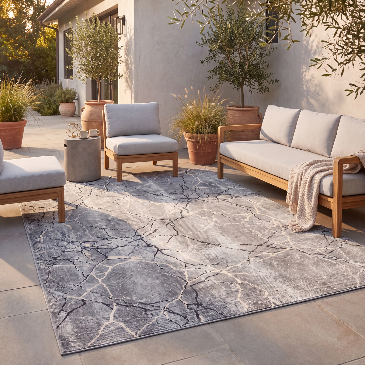 The rug laid flat on a patio beside outdoor seating.