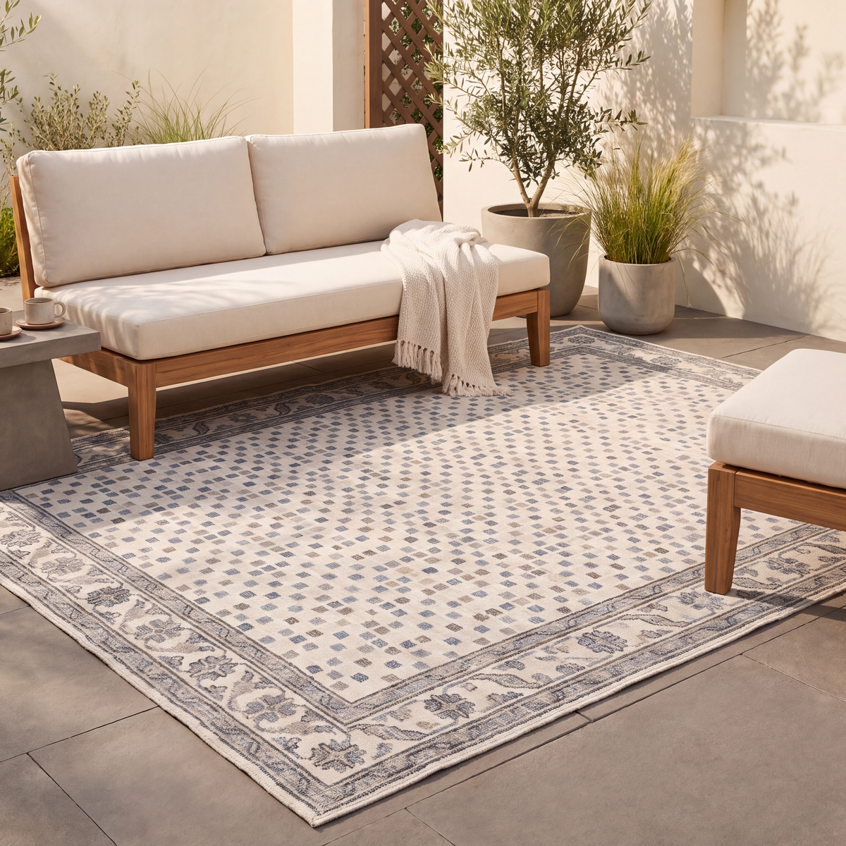 The rug laid flat on a patio beside outdoor seating.