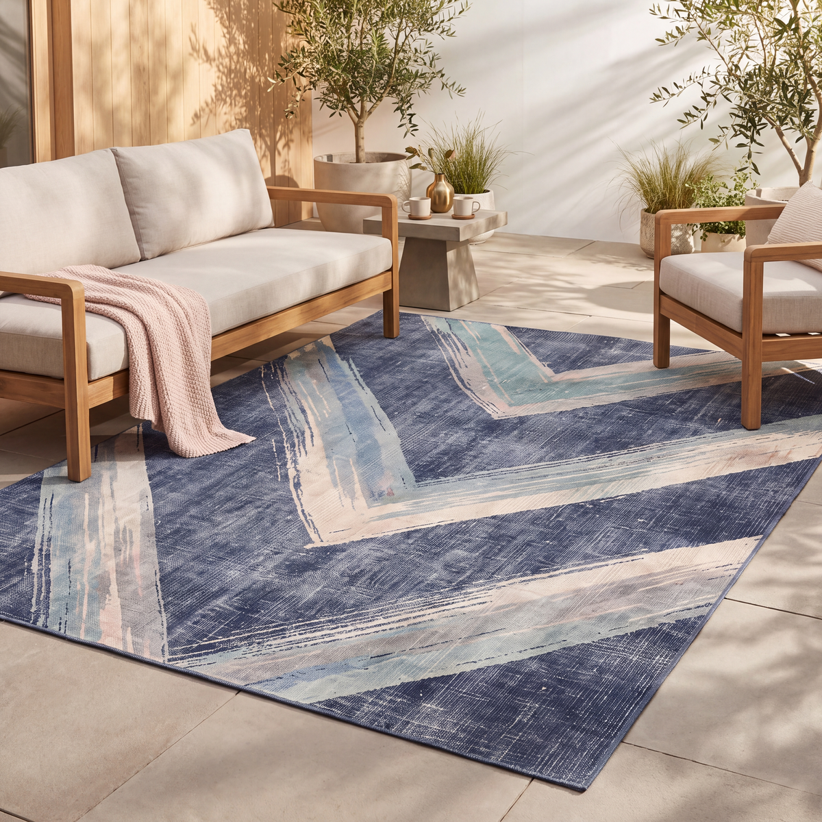 The rug laid flat on a patio beside outdoor seating.