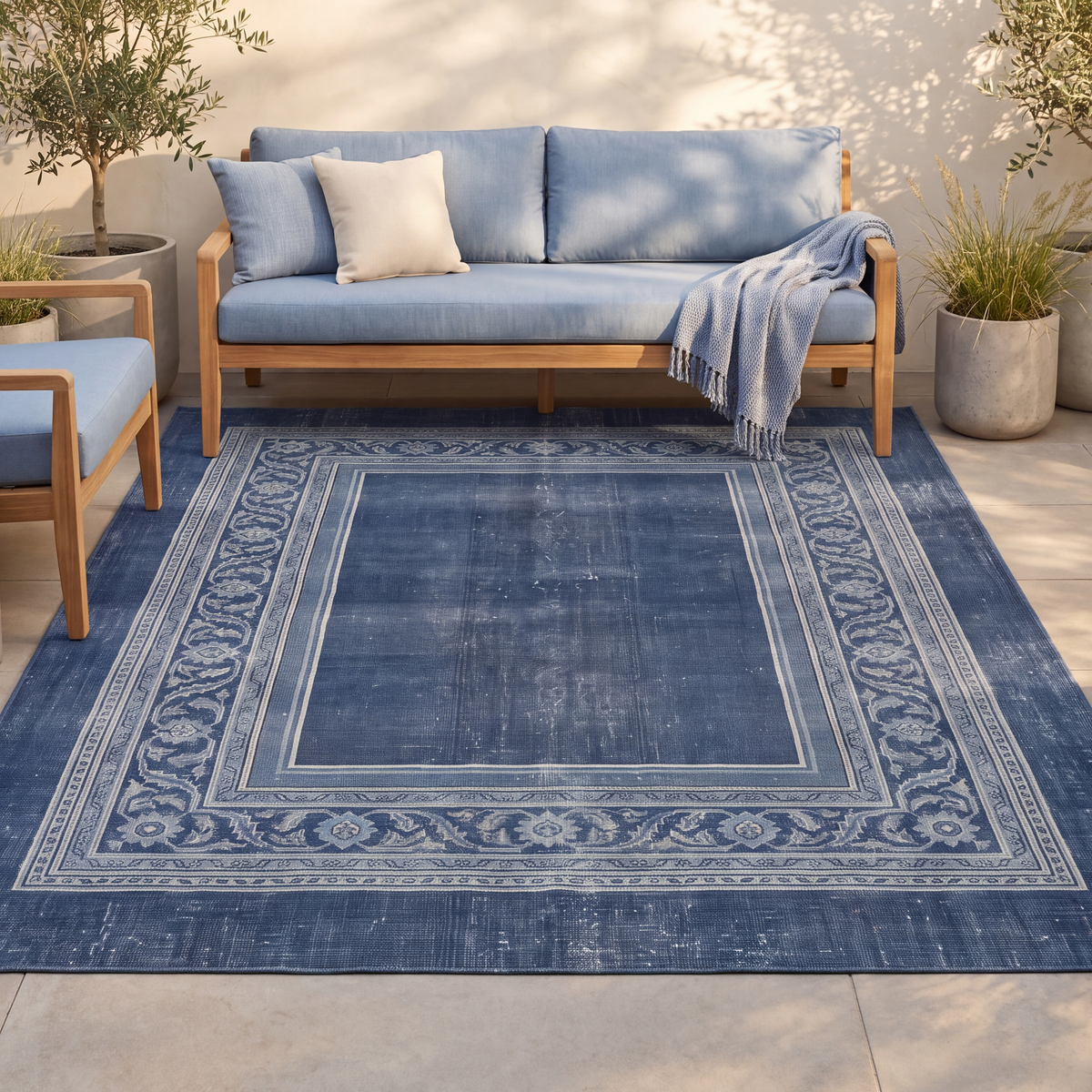 The rug laid flat on a patio beside outdoor seating.