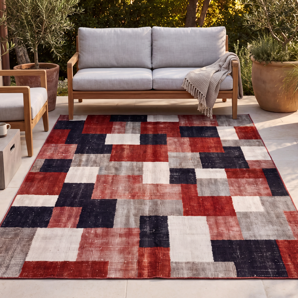 The rug laid flat on a patio beside outdoor seating.