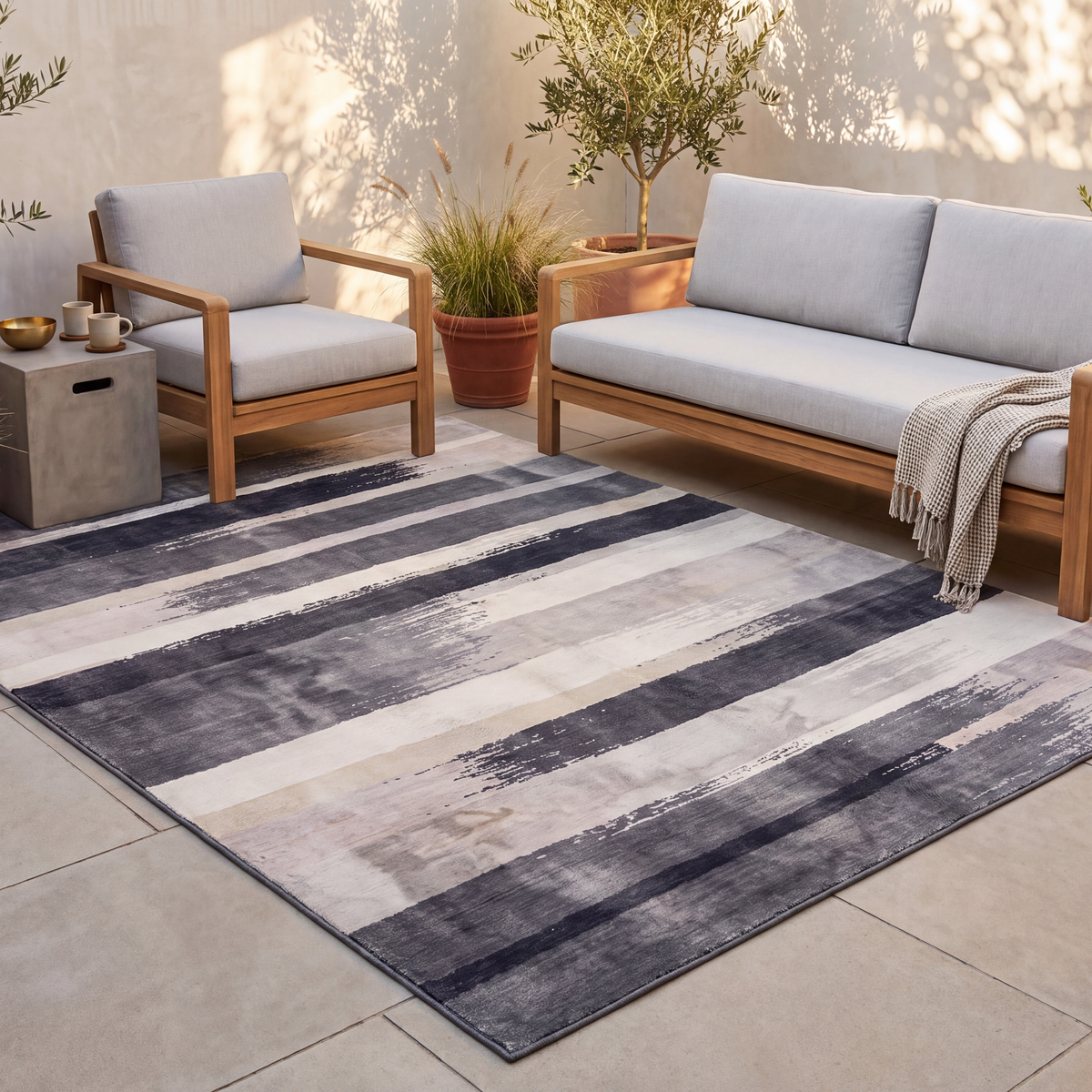 The rug laid flat on a patio beside outdoor seating.