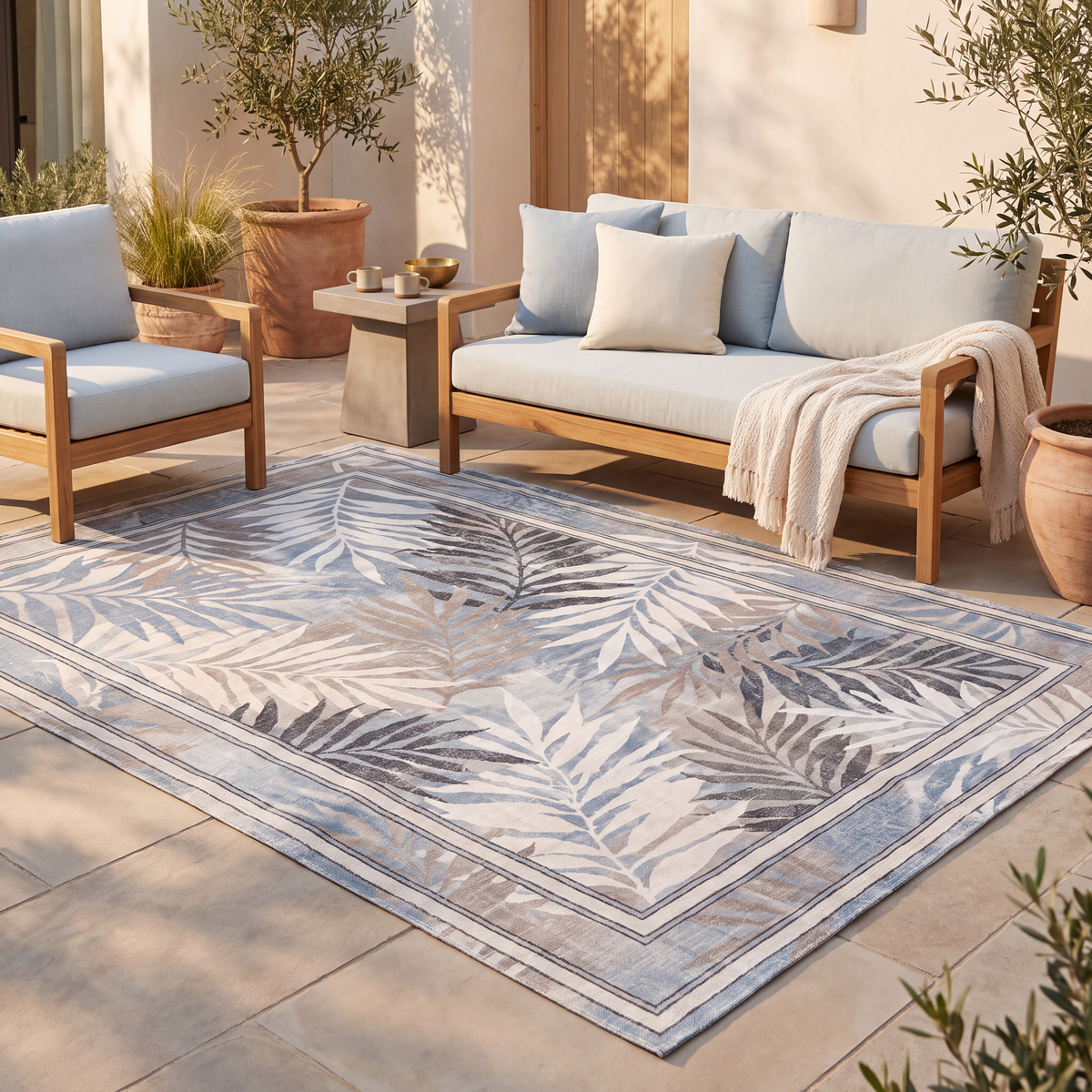 The rug laid flat on a patio beside outdoor seating.