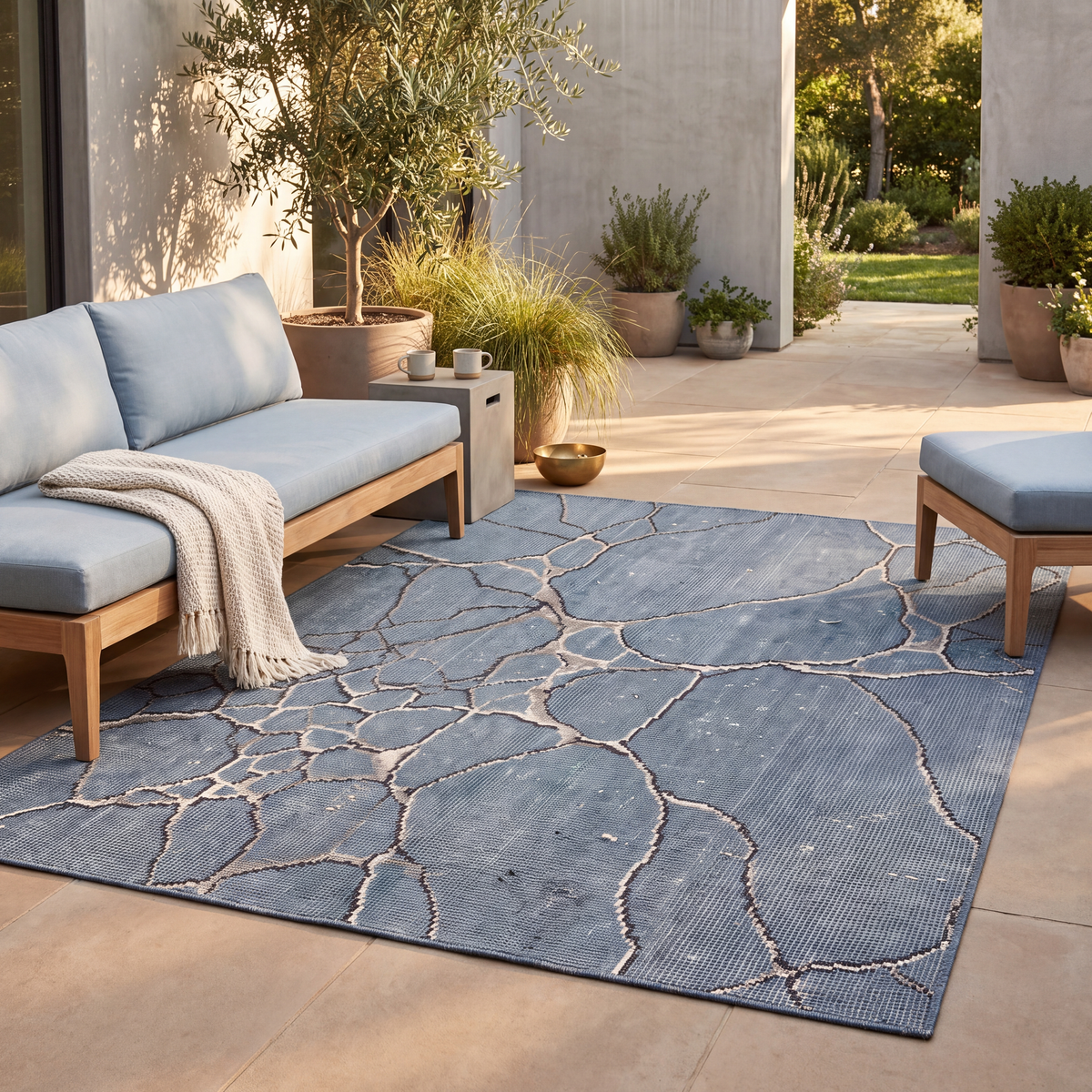 The rug laid flat on a patio beside outdoor seating.