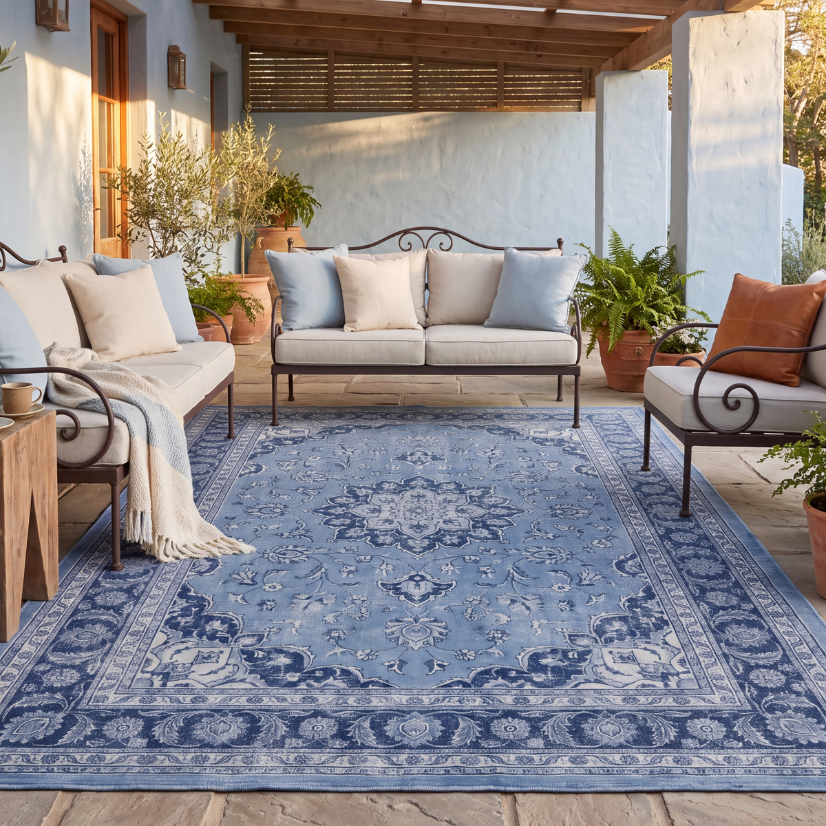 The rug laid flat on a patio beside outdoor seating.