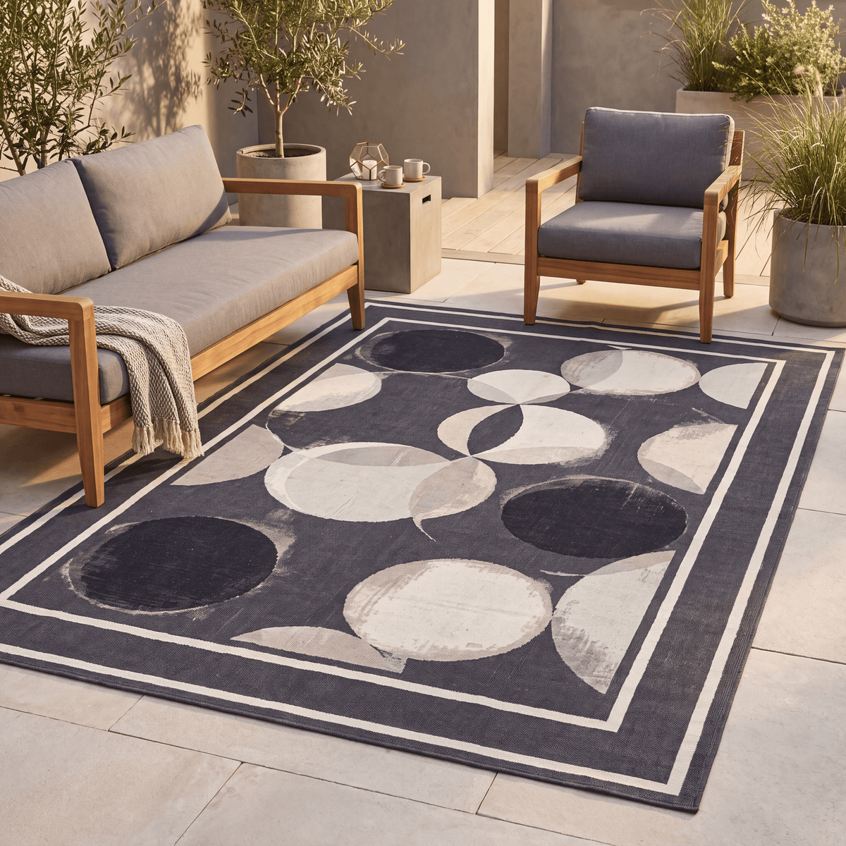 The rug laid flat on a patio beside outdoor seating.